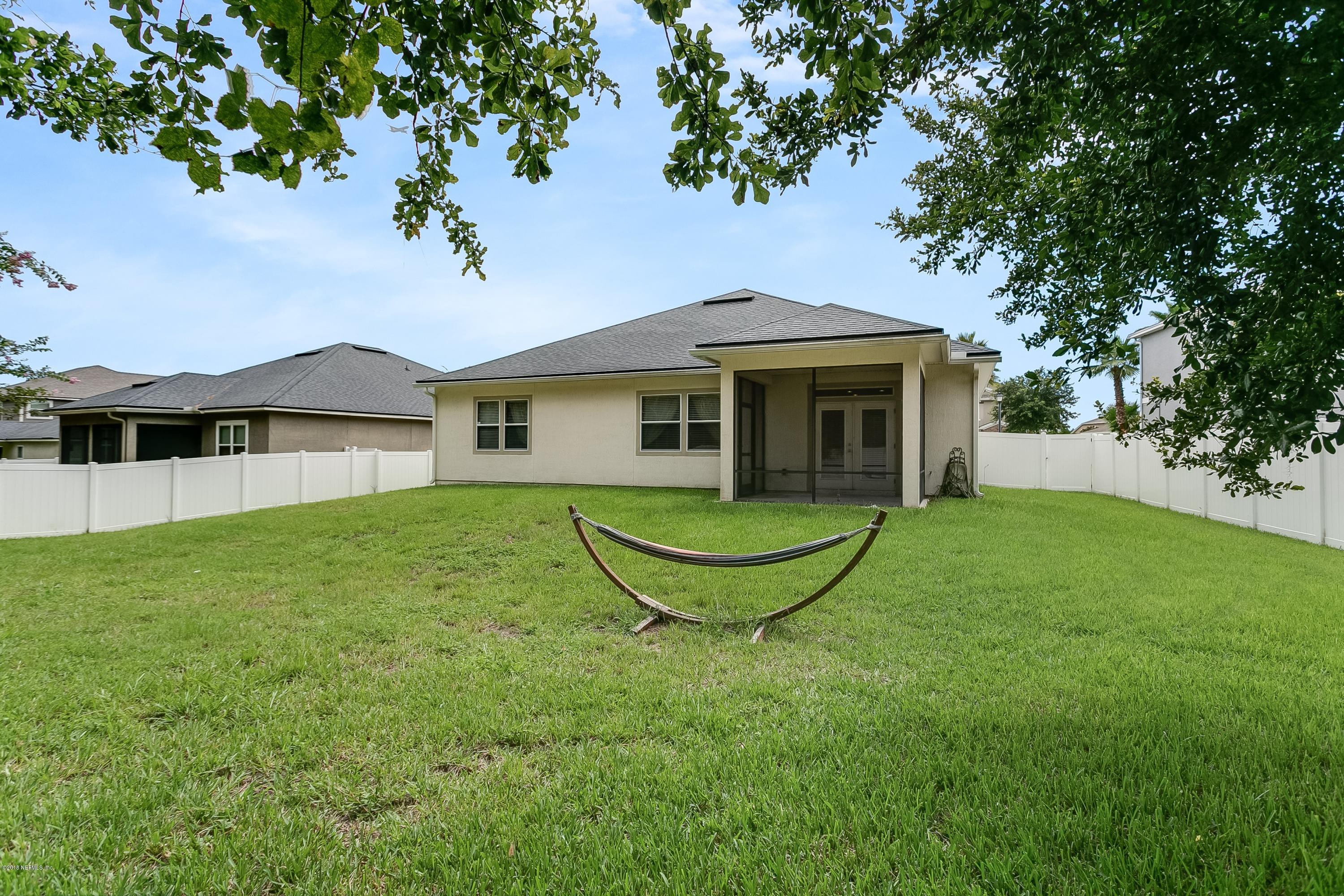 16378 Tisons Bluff Road Jacksonville, FL 32218 - Photo 23 of 24 a view of a house with a yard potted plants and large tree