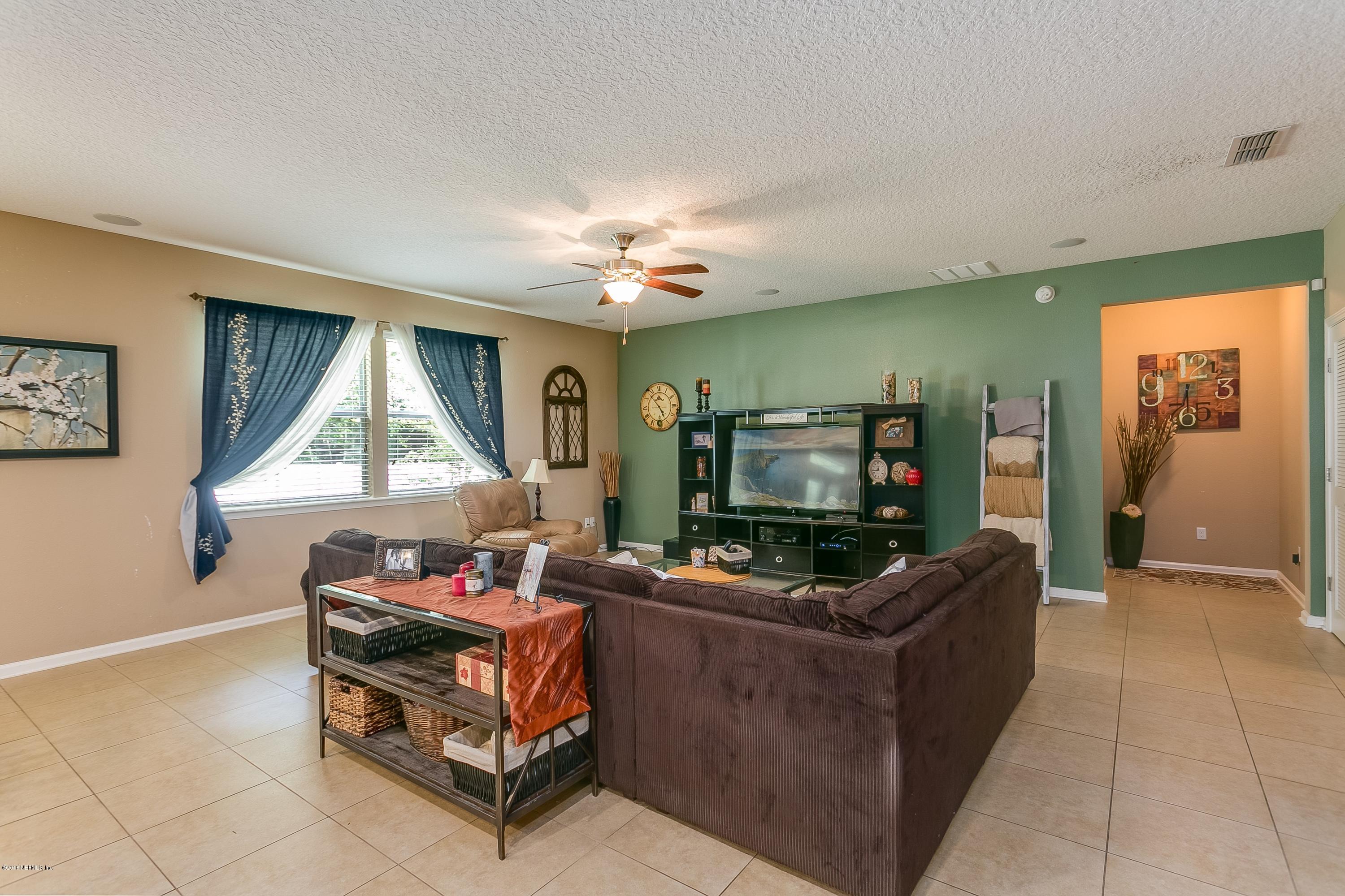 16378 Tisons Bluff Road Jacksonville, FL 32218 - Photo 4 of 24 a living room with furniture and a flat screen tv