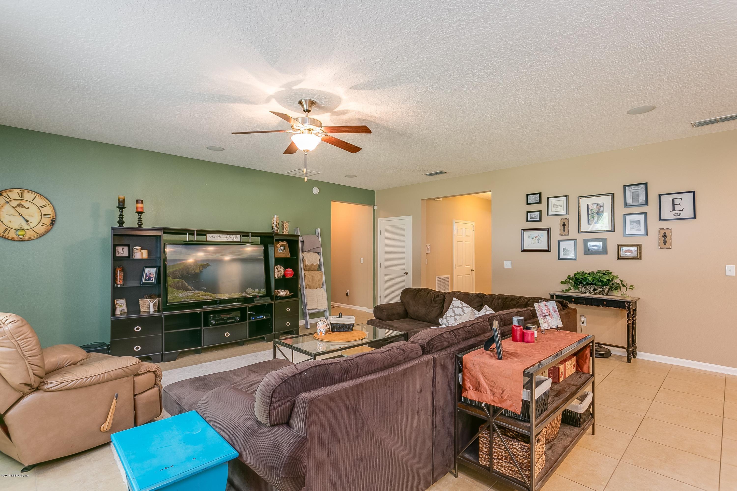 16378 Tisons Bluff Road Jacksonville, FL 32218 - Photo 5 of 24 a living room with furniture and a flat screen tv