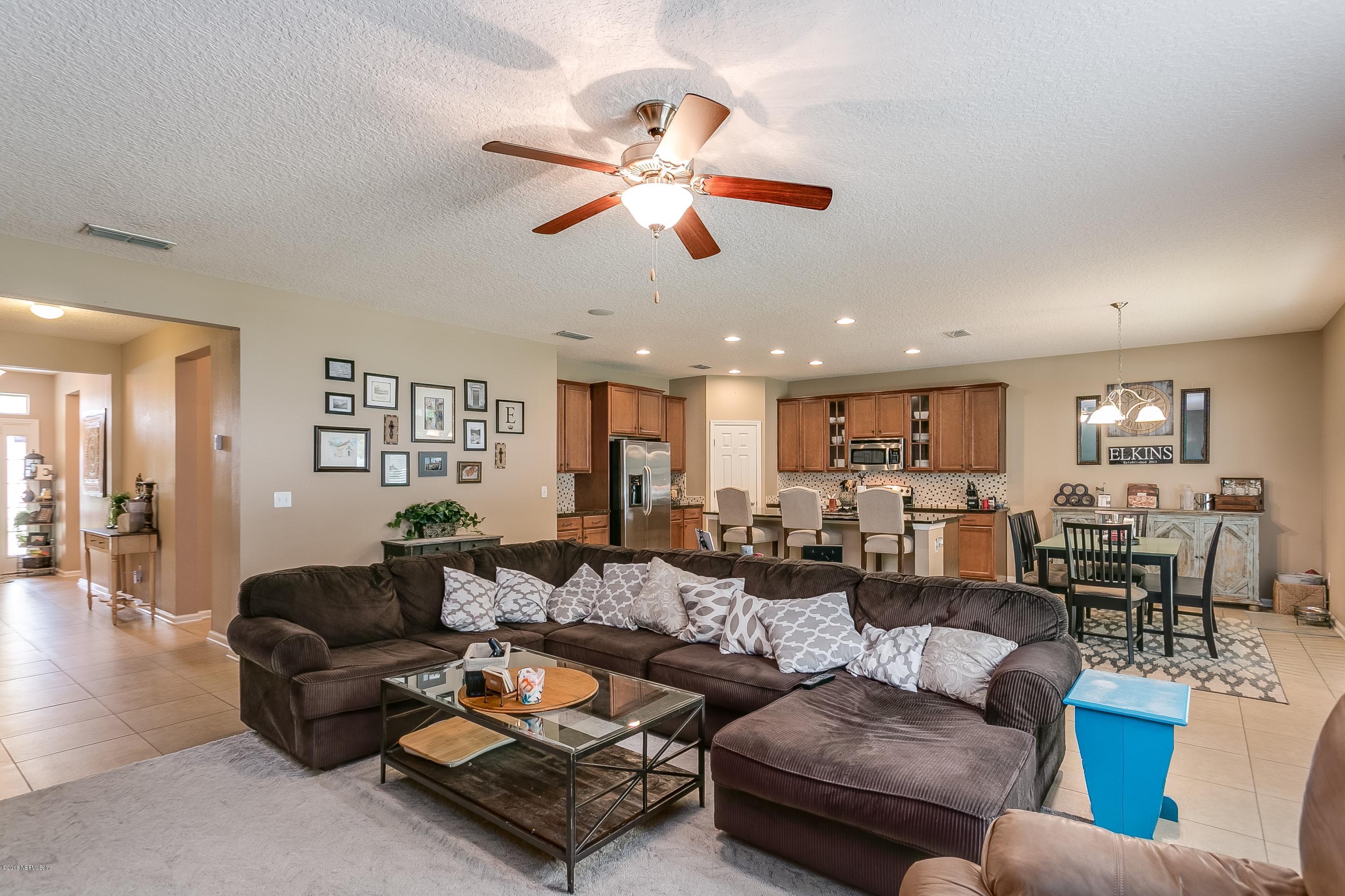 16378 Tisons Bluff Road Jacksonville, FL 32218 - Photo 6 of 24 a living room with furniture and a ceiling fan