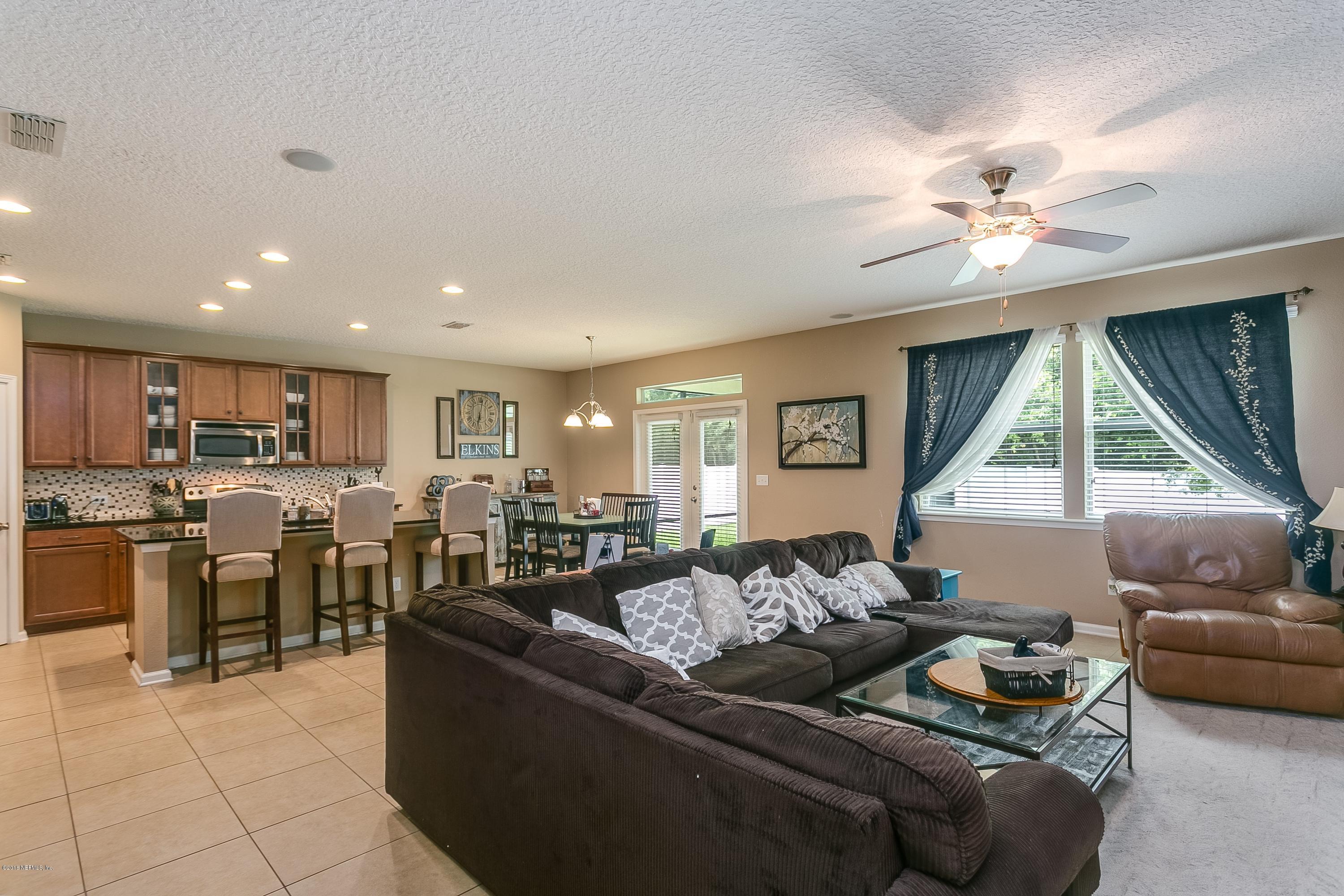 16378 Tisons Bluff Road Jacksonville, FL 32218 - Photo 7 of 24 a living room with furniture kitchen view and a large window