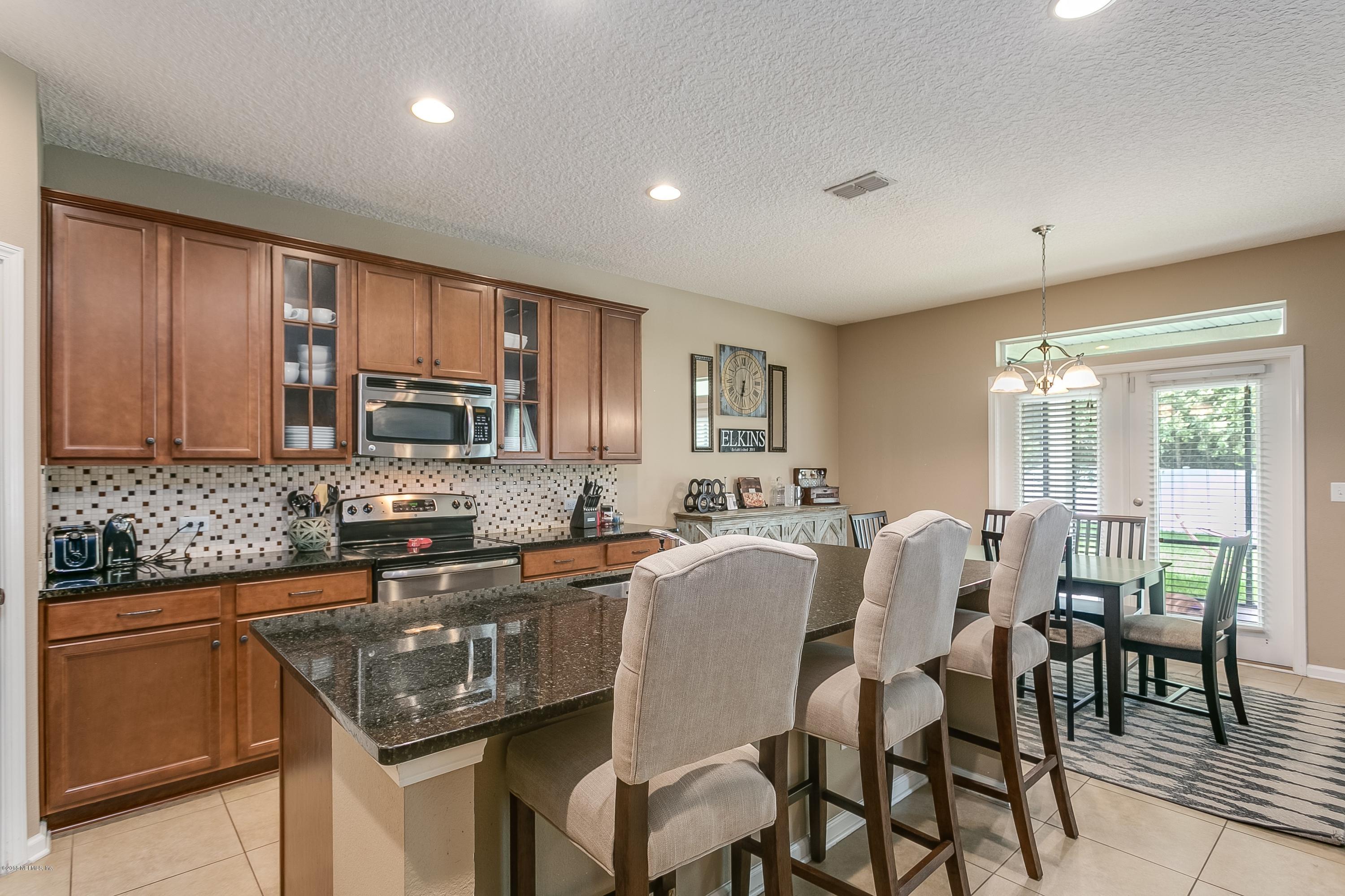 16378 Tisons Bluff Road Jacksonville, FL 32218 - Photo 8 of 24 a kitchen with granite countertop sink cabinets and dining table