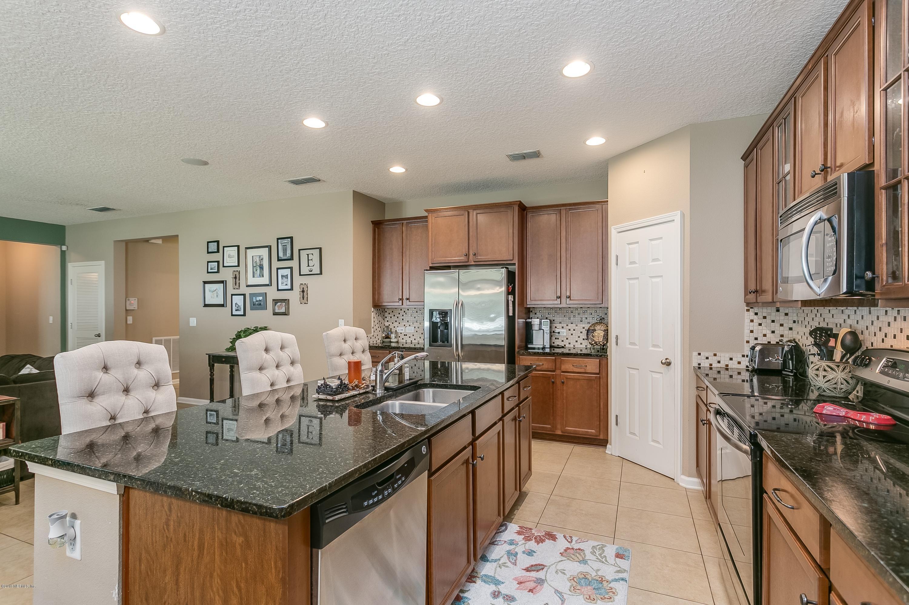 16378 Tisons Bluff Road Jacksonville, FL 32218 - Photo 10 of 24 a kitchen with stainless steel appliances granite countertop a sink stove and refrigerator