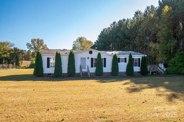 a view of a house with pool and yard
