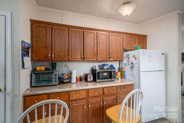 a kitchen with stainless steel appliances a refrigerator sink and cabinets