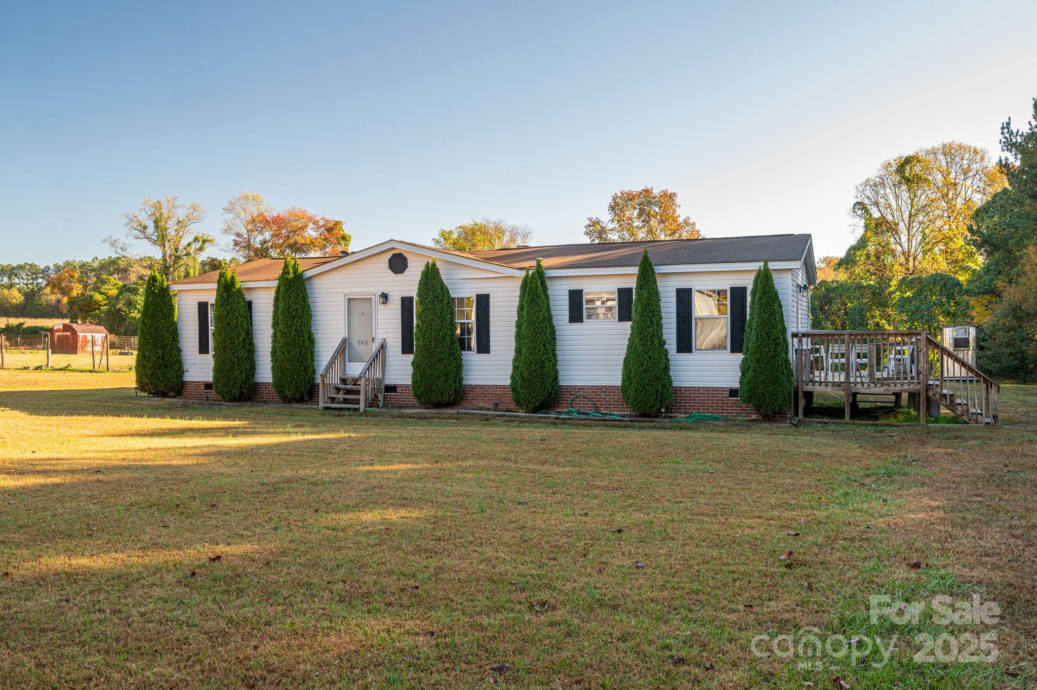866 Marys Grove Road Cherryville, NC 28021 - Photo 2 of 24 a front view of a house with a big yard and potted plants