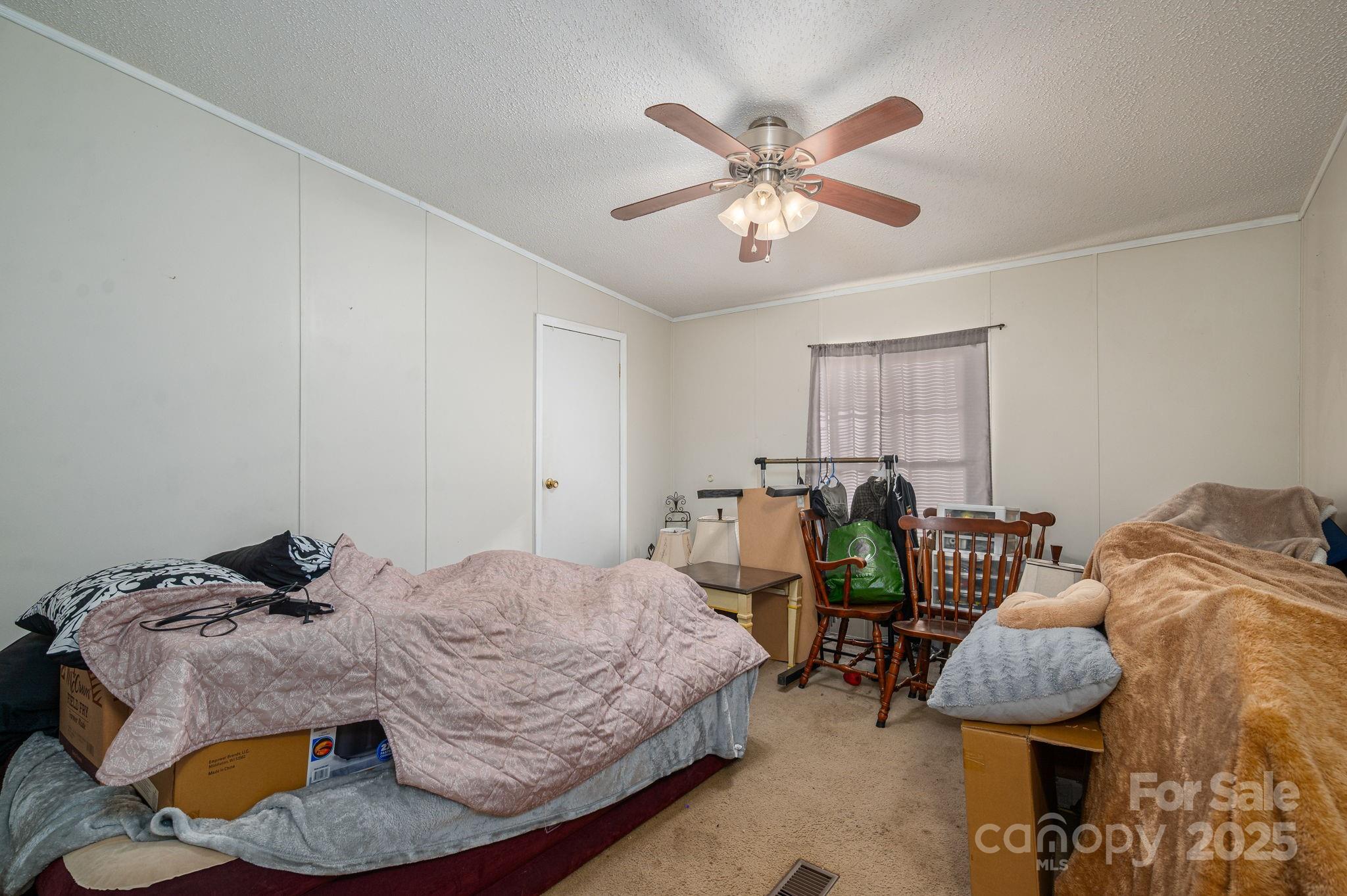 866 Marys Grove Road Cherryville, NC 28021 - Photo 22 of 24 a bedroom with bed and a chandelier