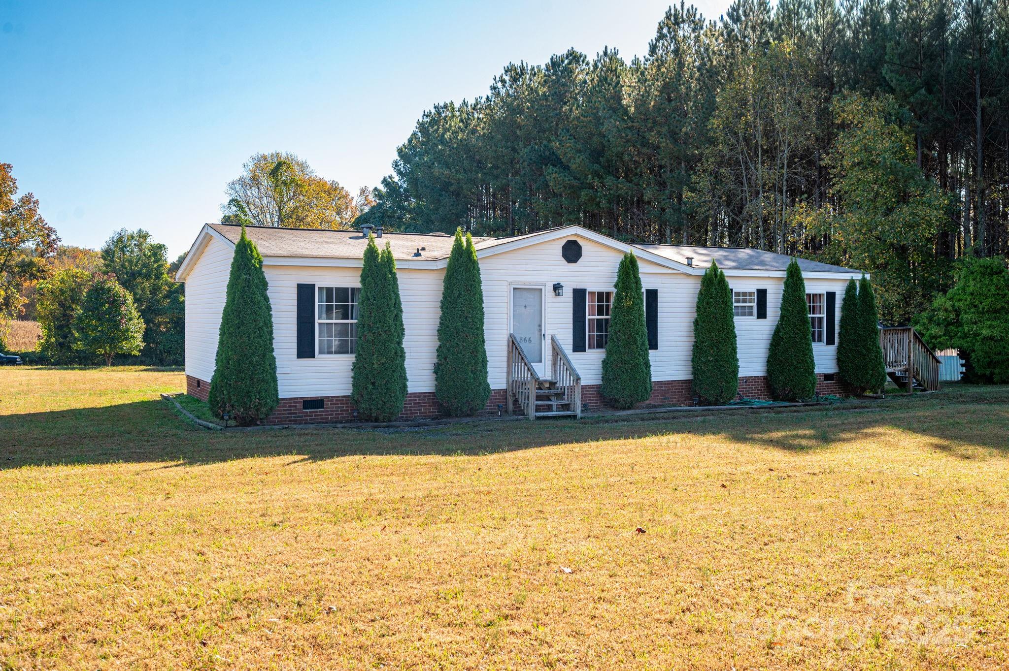 866 Marys Grove Road Cherryville, NC 28021 - Photo 3 of 24 a view of a house with swimming pool and a yard