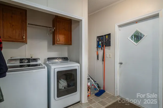 a view of a kitchen with fridge and wooden floor