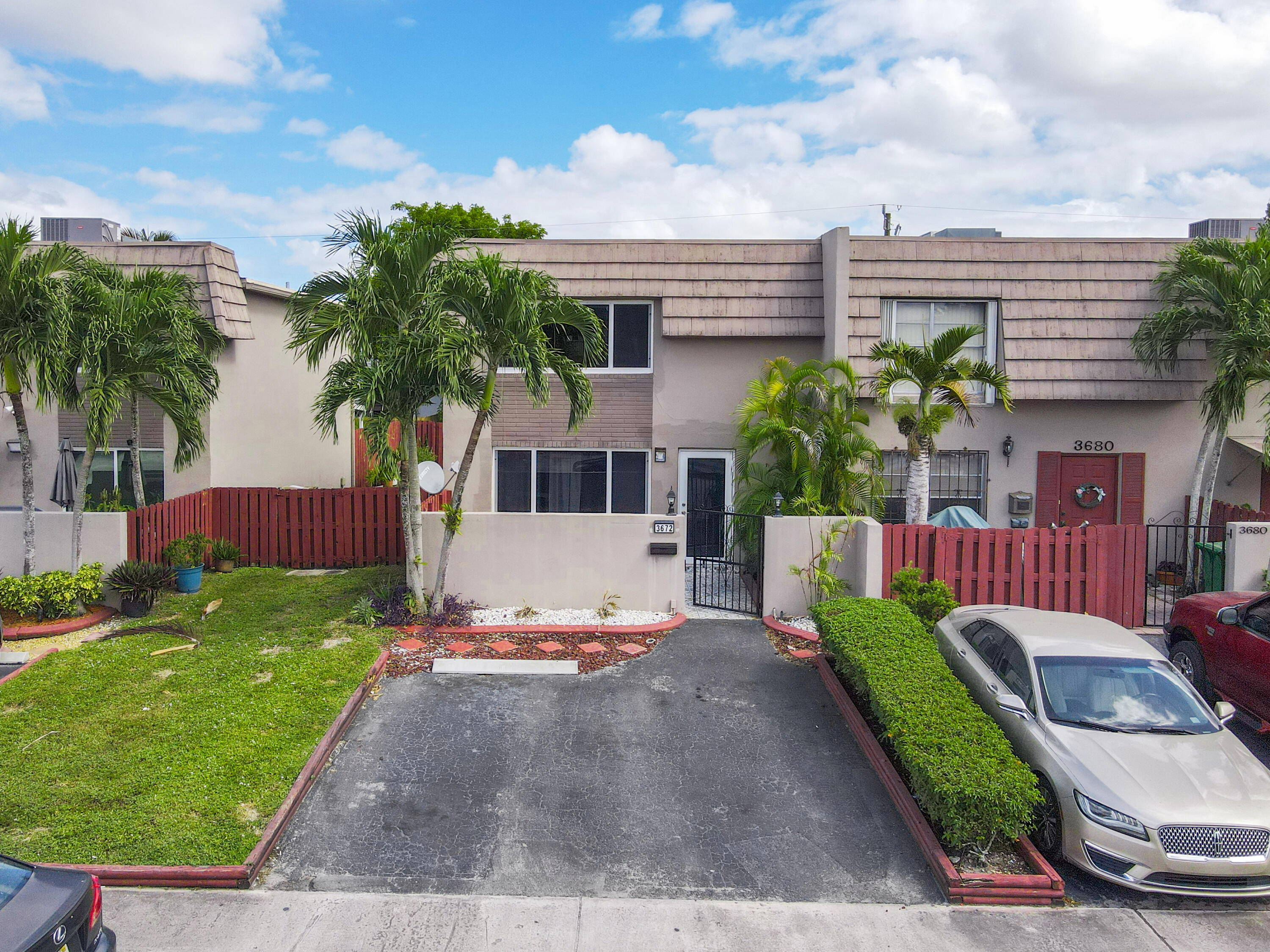 3672 Southwest 59th Terrace, Unit 73 Davie, FL 33314 - Photo 1 of 39 a front view of a house with garden
