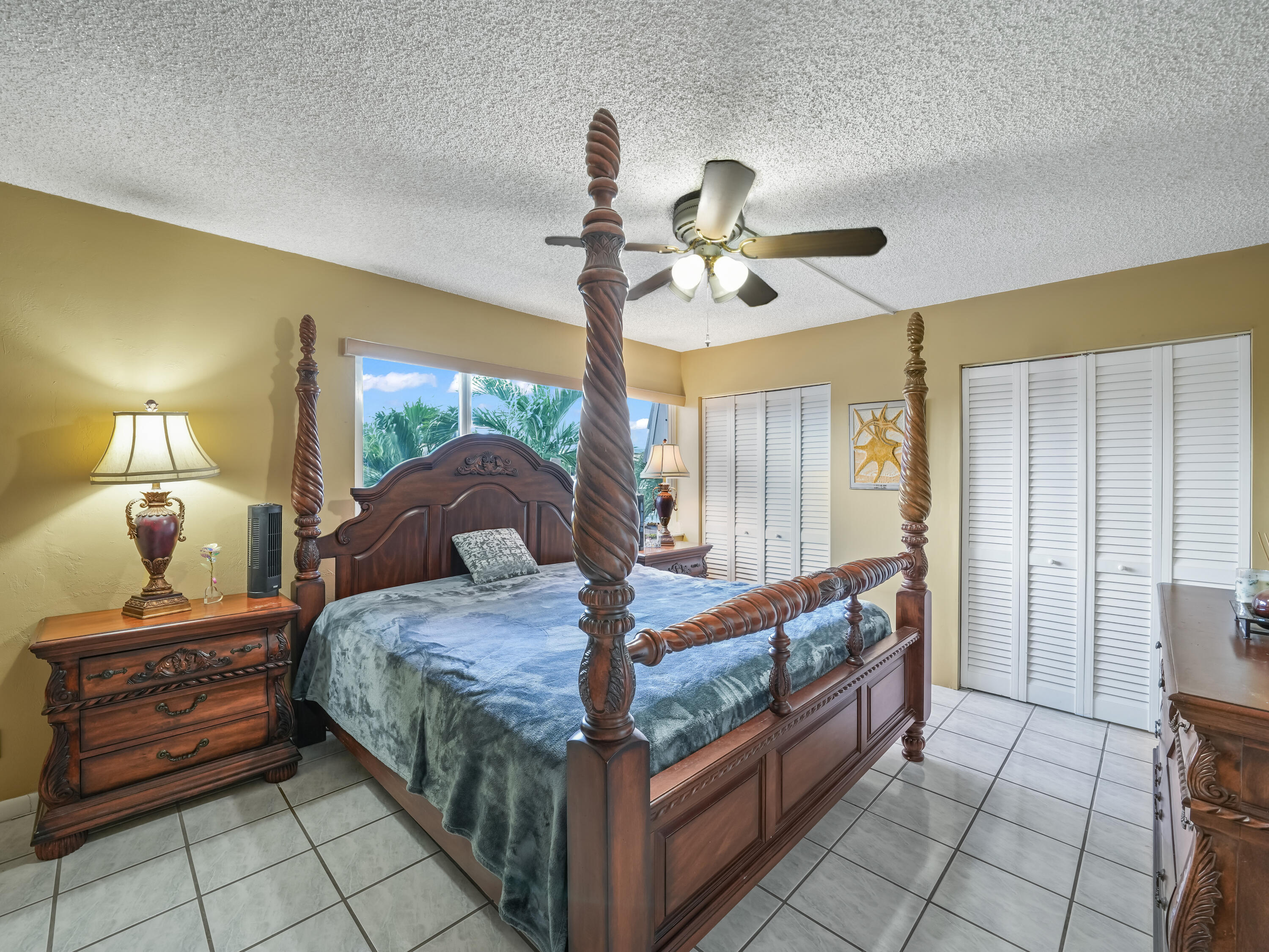 3672 Southwest 59th Terrace, Unit 73 Davie, FL 33314 - Photo 16 of 39 a bed room with a bed and a chandelier