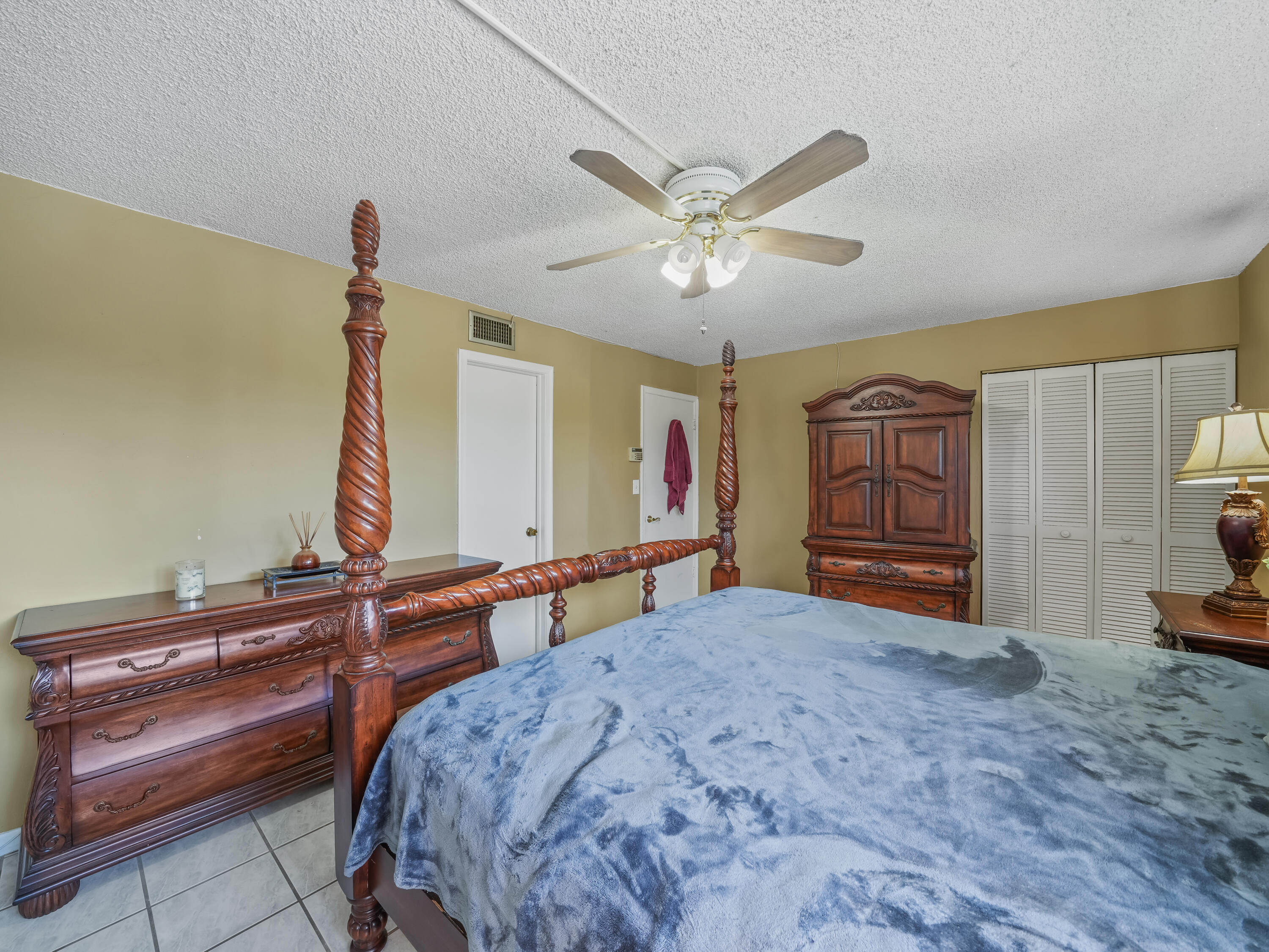 3672 Southwest 59th Terrace, Unit 73 Davie, FL 33314 - Photo 18 of 39 a bedroom with a bed and a chandelier
