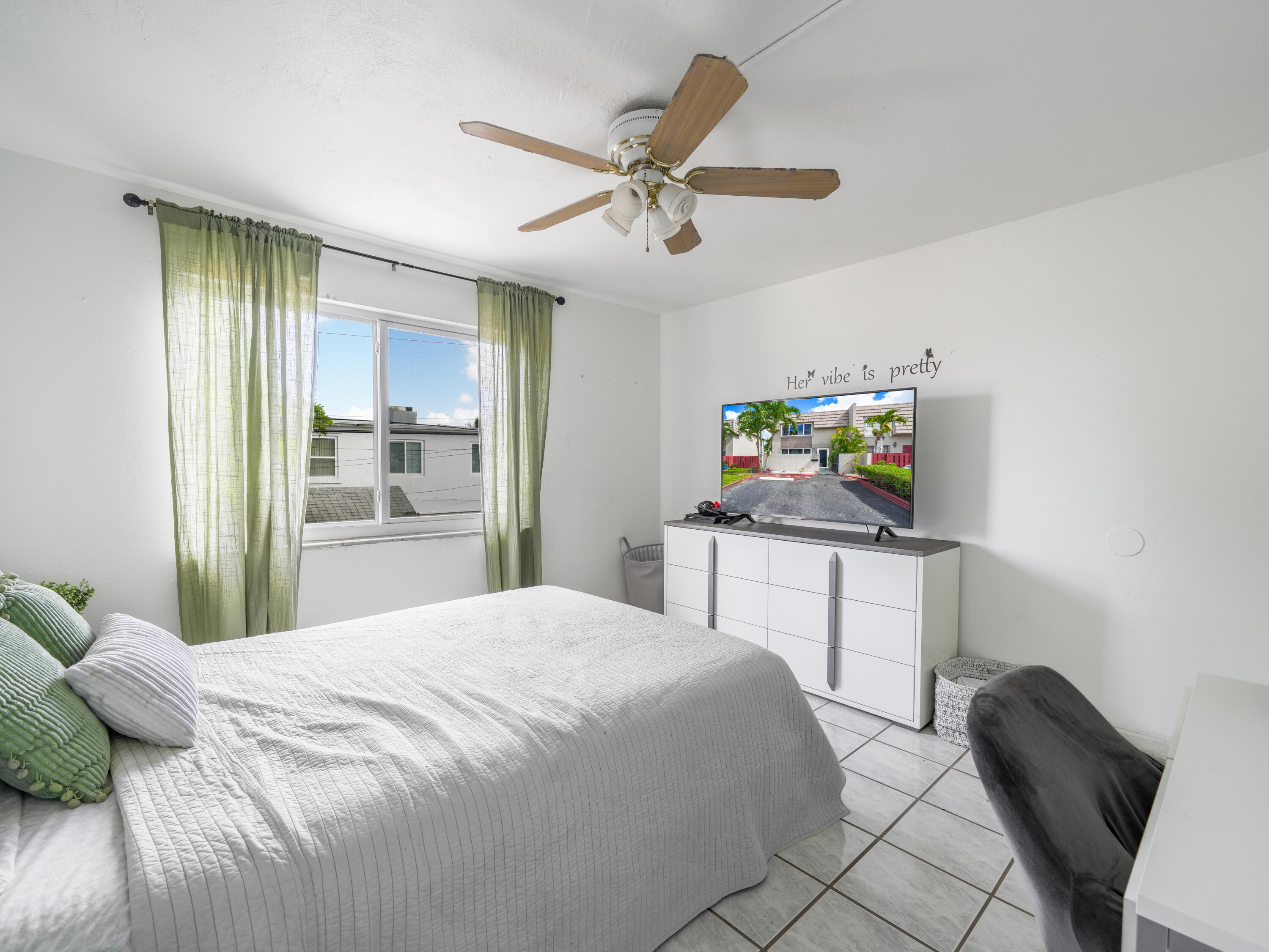 3672 Southwest 59th Terrace, Unit 73 Davie, FL 33314 - Photo 21 of 39 a bedroom with a bed and a table in it