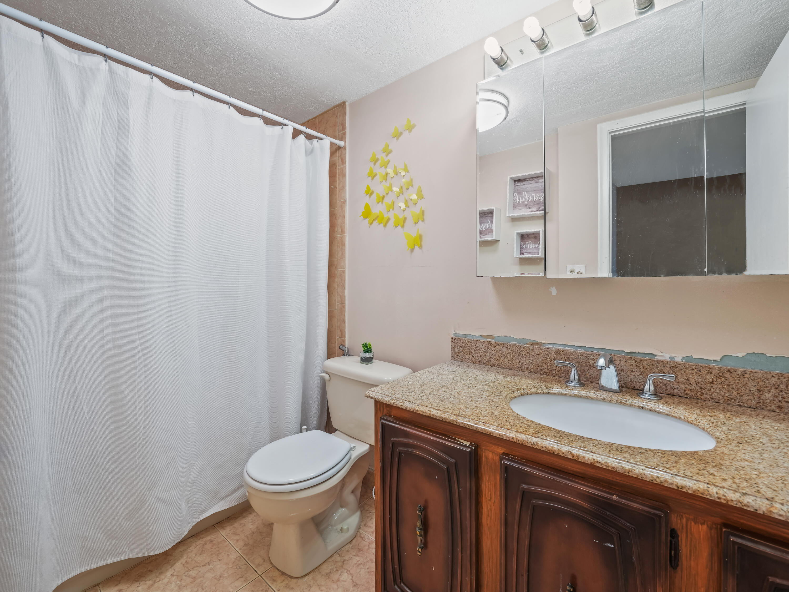 3672 Southwest 59th Terrace, Unit 73 Davie, FL 33314 - Photo 22 of 39 a bathroom with a granite countertop sink and a mirror