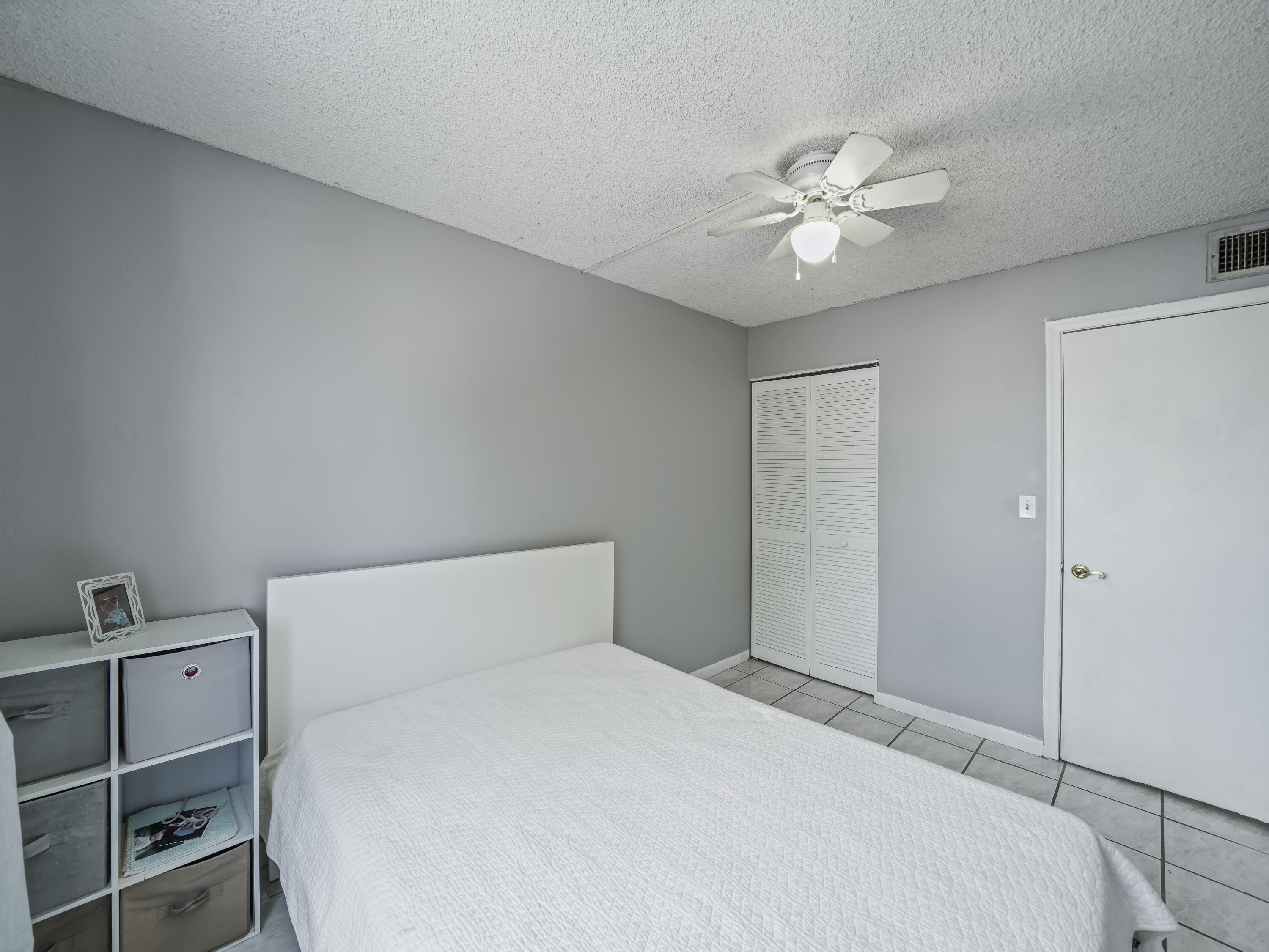 3672 Southwest 59th Terrace, Unit 73 Davie, FL 33314 - Photo 23 of 39 a bedroom with a bed and a chandelier