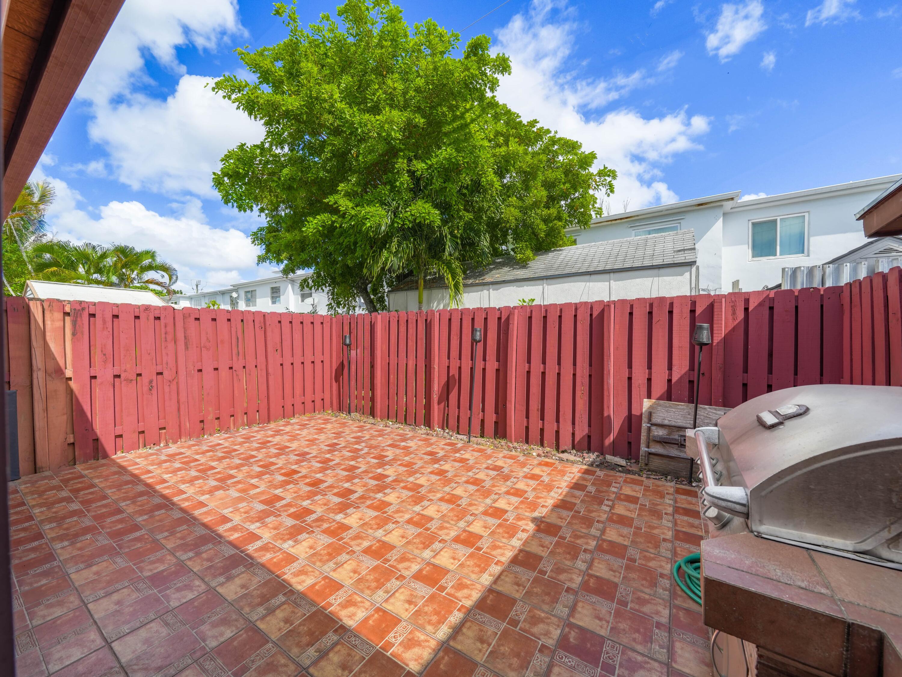3672 Southwest 59th Terrace, Unit 73 Davie, FL 33314 - Photo 29 of 39 a view of a backyard with a chair and table