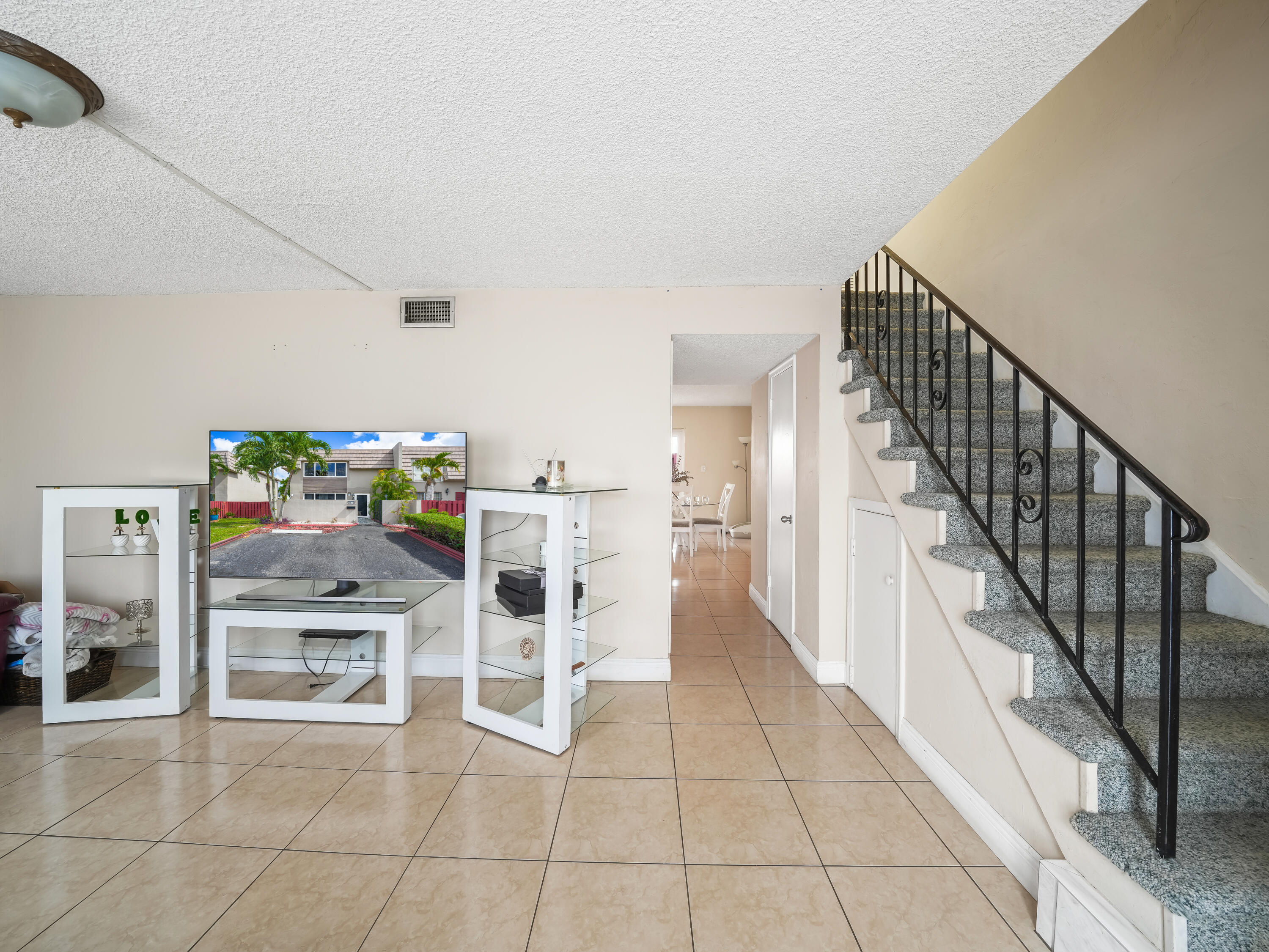 3672 Southwest 59th Terrace, Unit 73 Davie, FL 33314 - Photo 7 of 39 a dining room with wooden floor and stairs