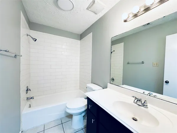 an empty room with a window and ceiling fan