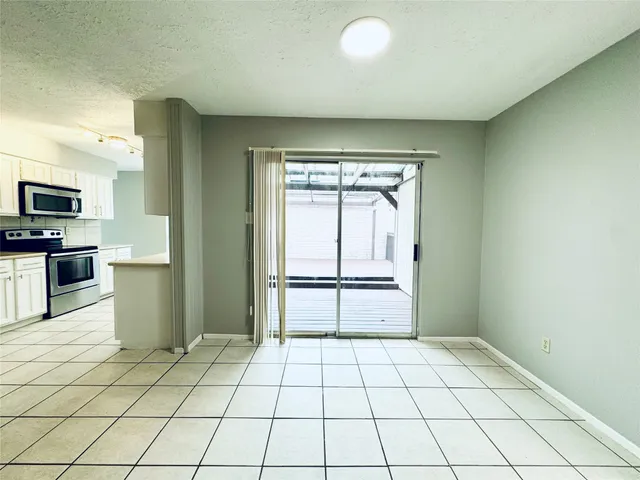 a view of a kitchen with a sink and a refrigerator