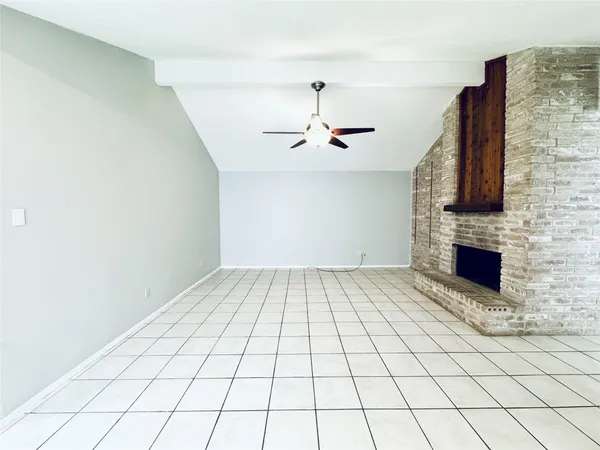 a view of an empty room with a fireplace
