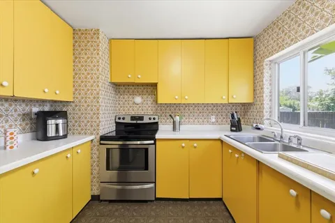 a kitchen with a sink and a stove
