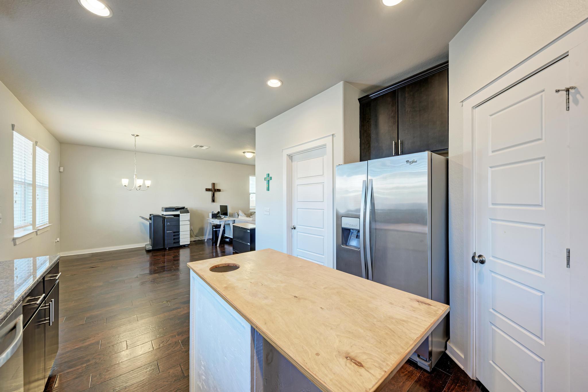 5305 Ingersoll Lane Austin, TX 78744 - Photo 10 of 27 a kitchen with sink refrigerator and cabinets