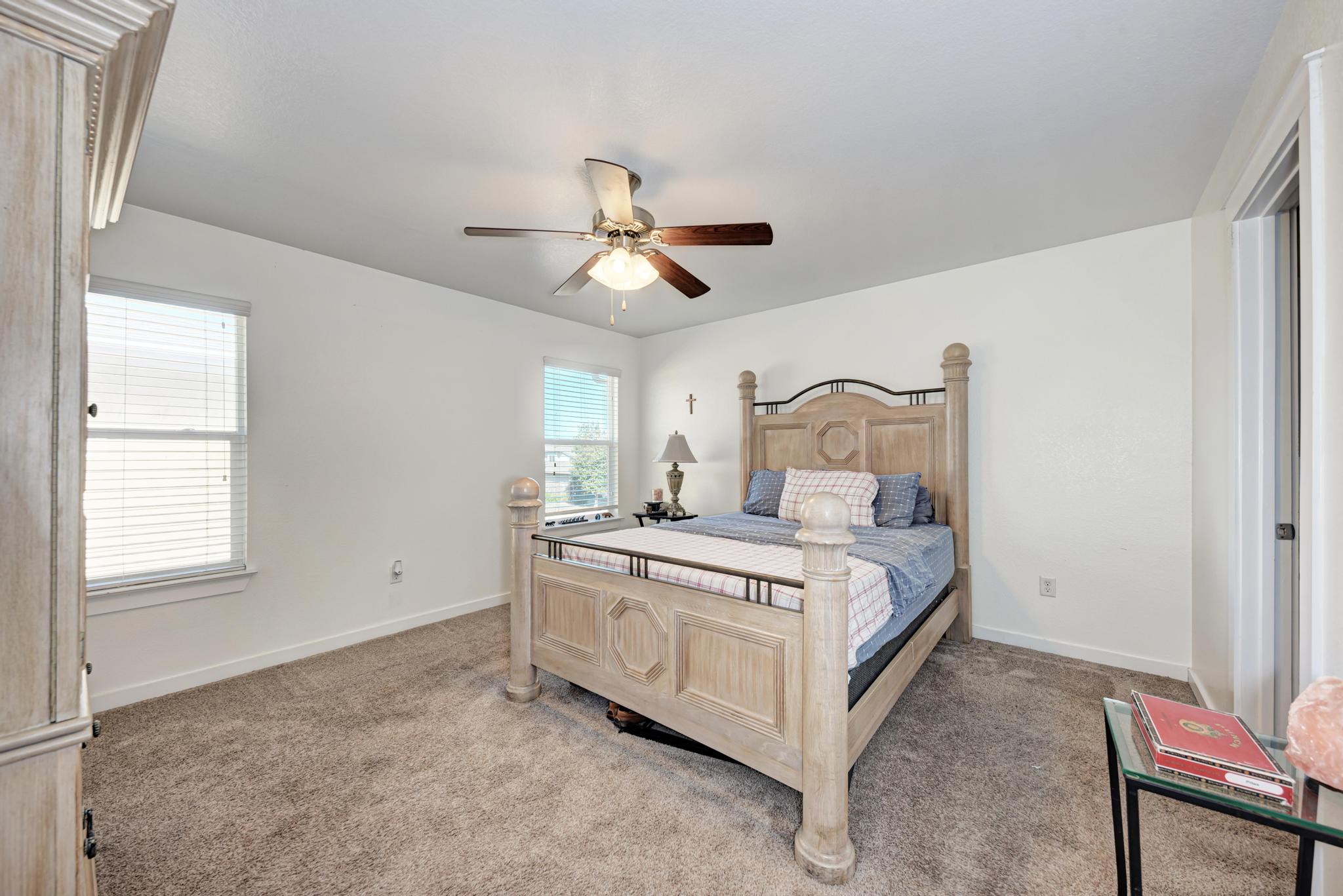 5305 Ingersoll Lane Austin, TX 78744 - Photo 16 of 27 a bed room with a bed and a ceiling fan