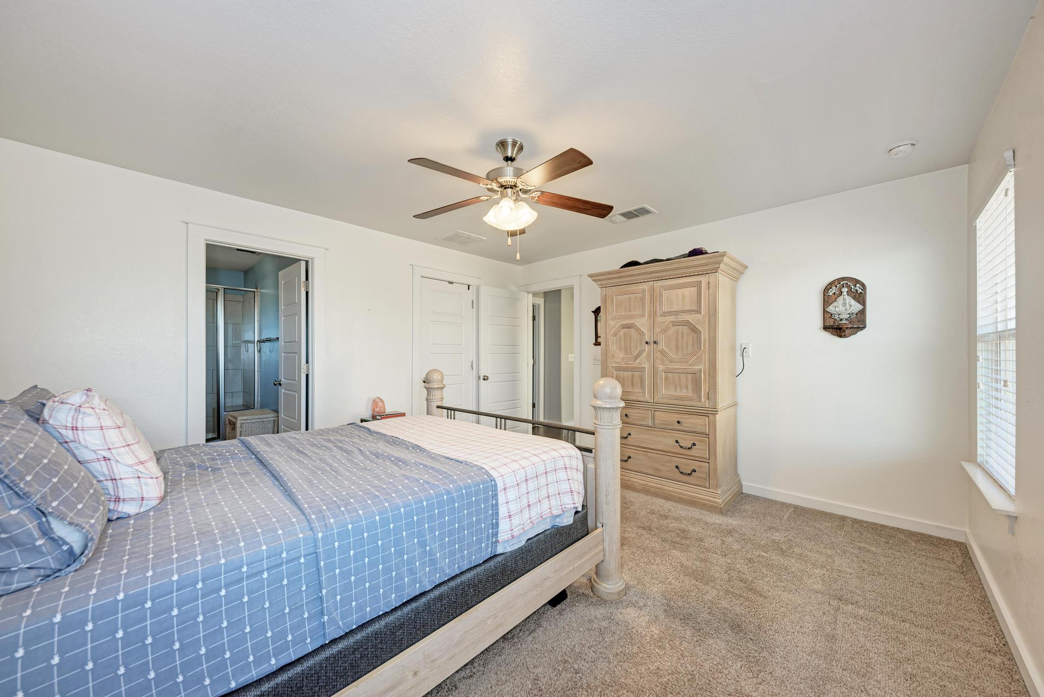 5305 Ingersoll Lane Austin, TX 78744 - Photo 17 of 27 a bedroom with a bed and a ceiling fan