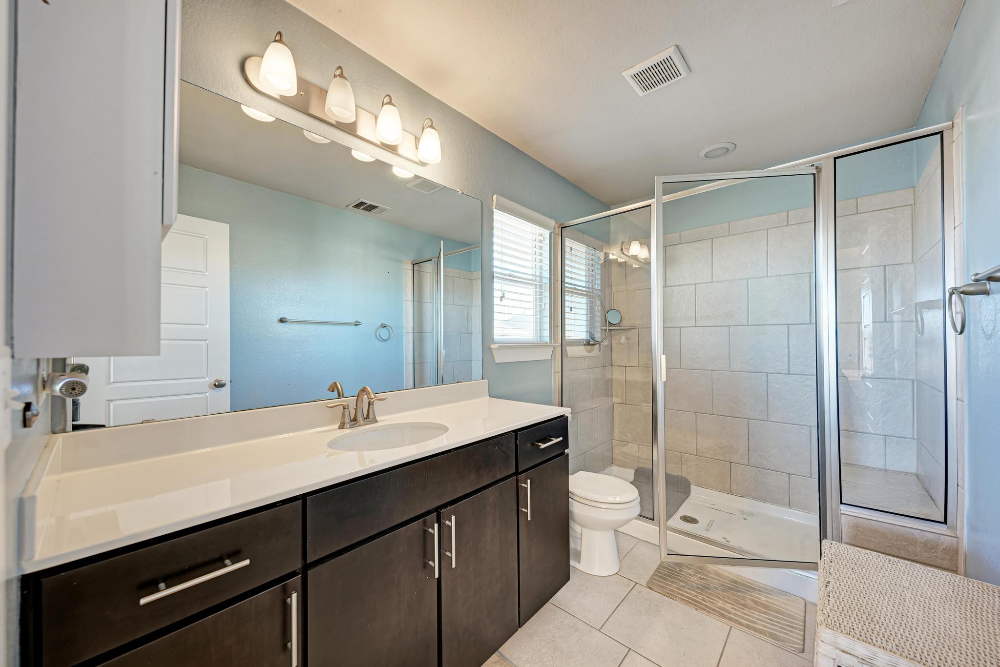 5305 Ingersoll Lane Austin, TX 78744 - Photo 18 of 27 a bathroom with a double vanity sink toilet and shower