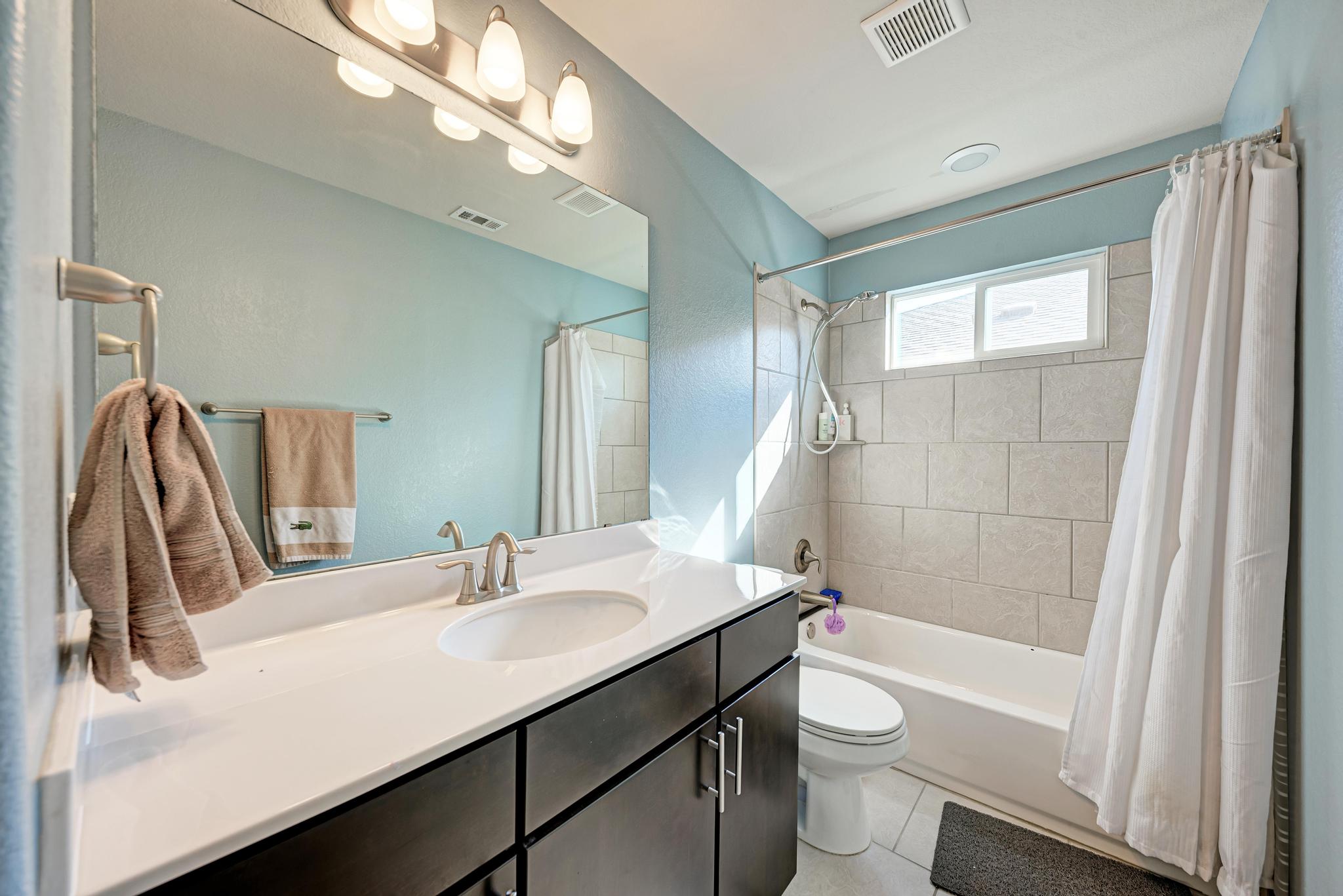5305 Ingersoll Lane Austin, TX 78744 - Photo 20 of 27 a bathroom with a sink a toilet and shower