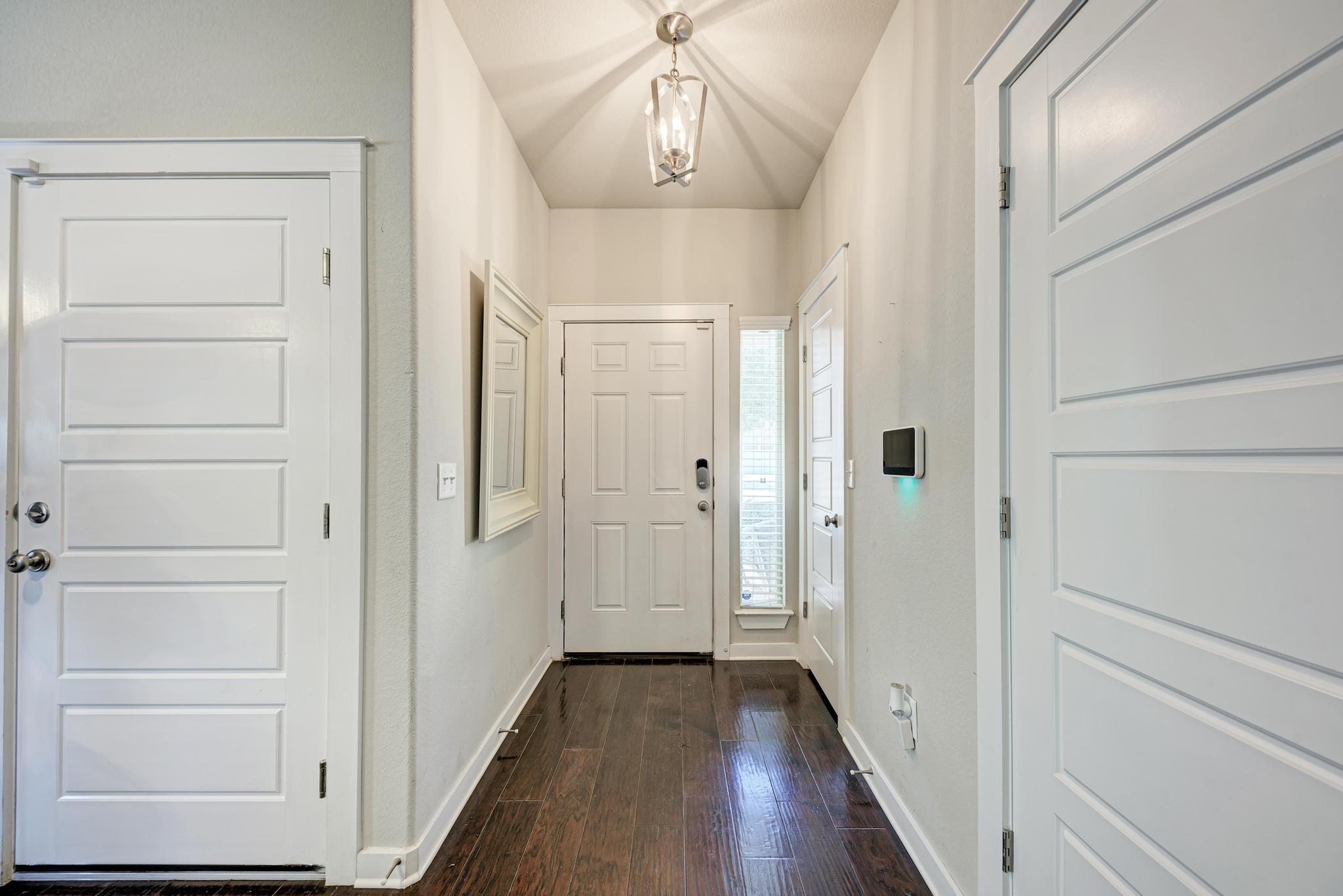 5305 Ingersoll Lane Austin, TX 78744 - Photo 3 of 27 a view of a hallway with wooden floor