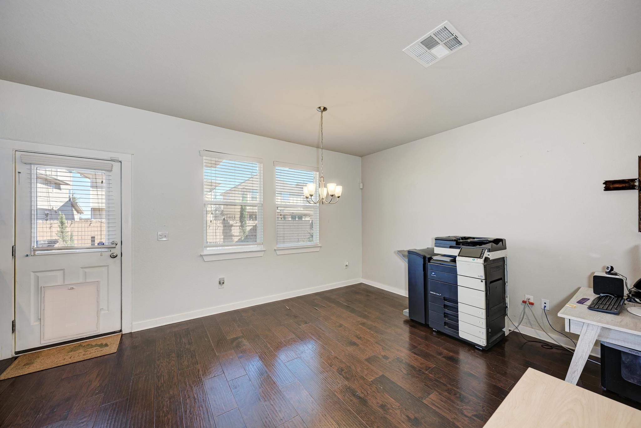 5305 Ingersoll Lane Austin, TX 78744 - Photo 8 of 27 a view of an empty room with wooden floor and a window
