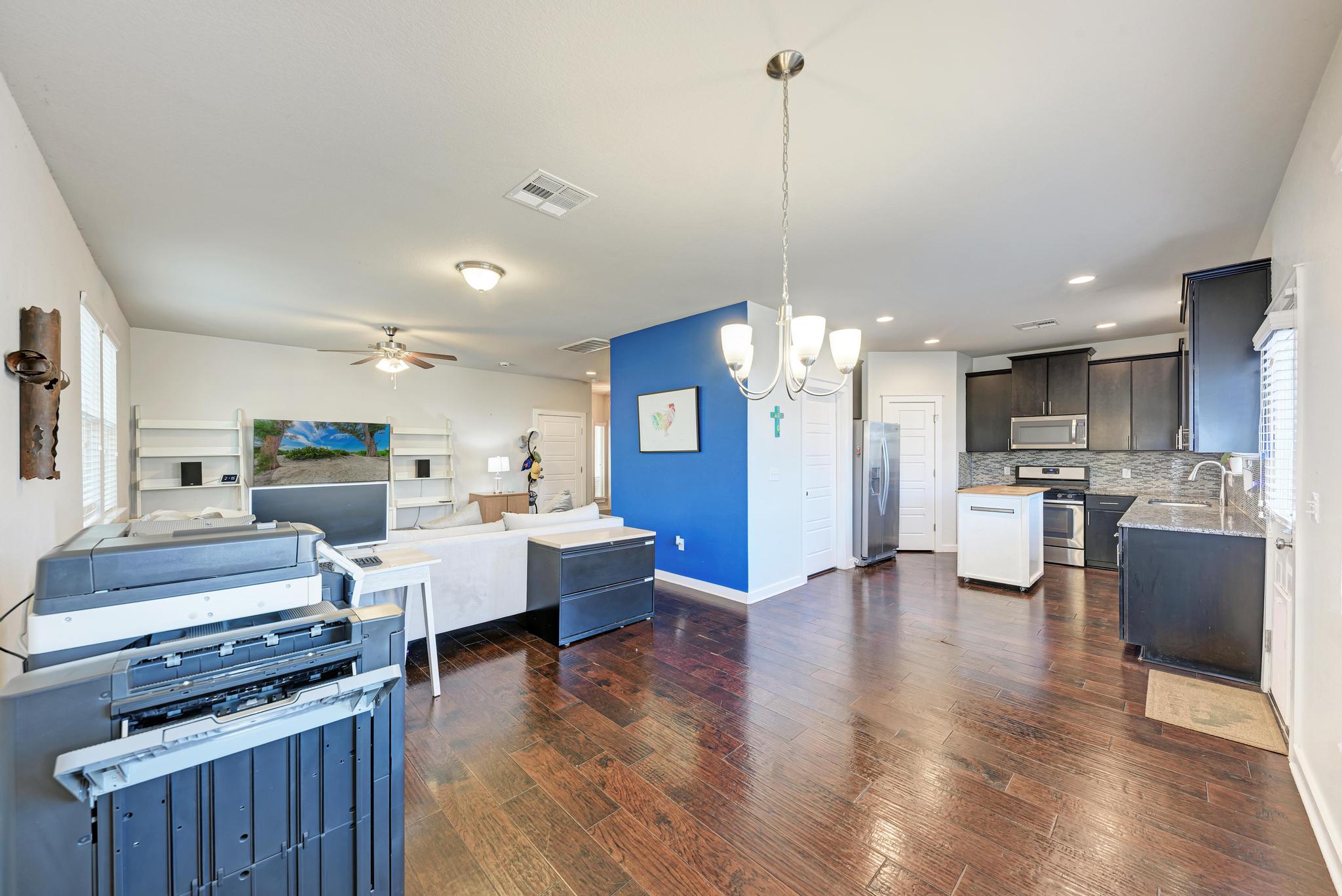 5305 Ingersoll Lane Austin, TX 78744 - Photo 27 of 27 a living room with stainless steel appliances kitchen island furniture and wooden floor