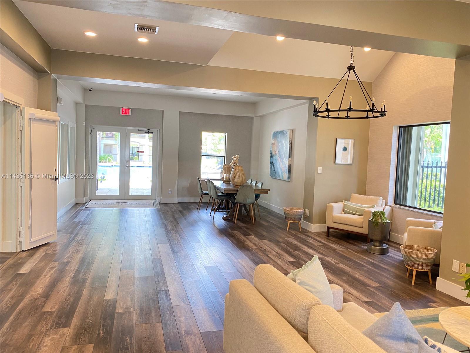 610 South Park Road, Unit 151 Hollywood, FL 33021 - Photo 32 of 34 a living room with furniture and a chandelier
