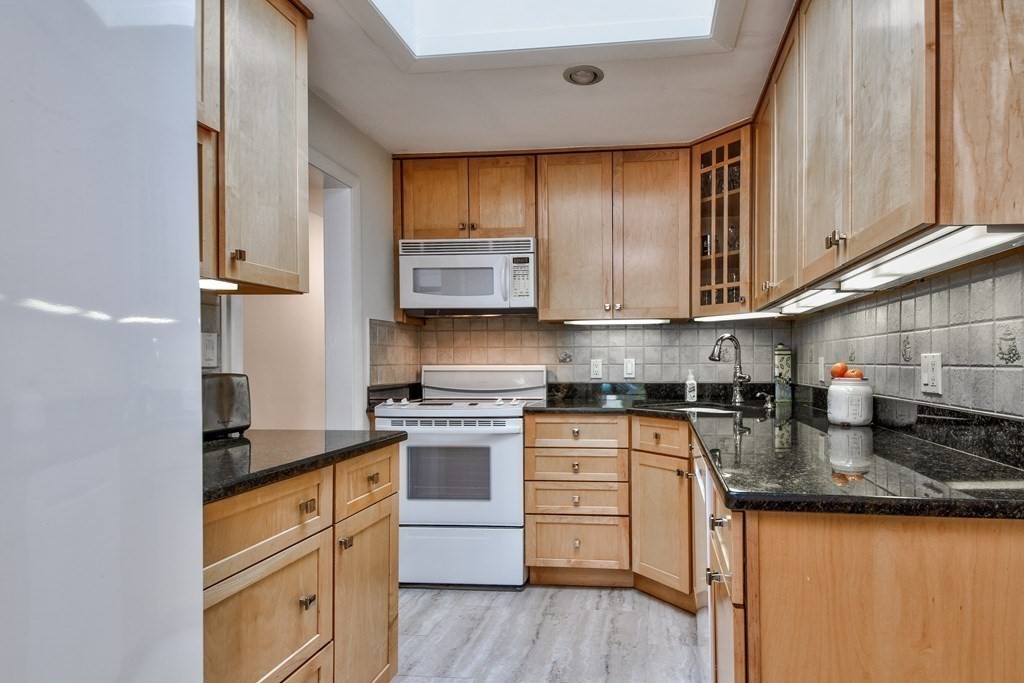 2 Gilmore Road Southborough, MA 01772 - Photo 11 of 33 a kitchen with stainless steel appliances granite countertop wooden cabinets granite counter tops and a hard wood floors