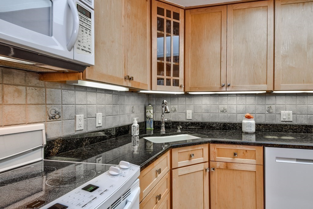 2 Gilmore Road Southborough, MA 01772 - Photo 12 of 33 a kitchen with granite countertop a stove and cabinets