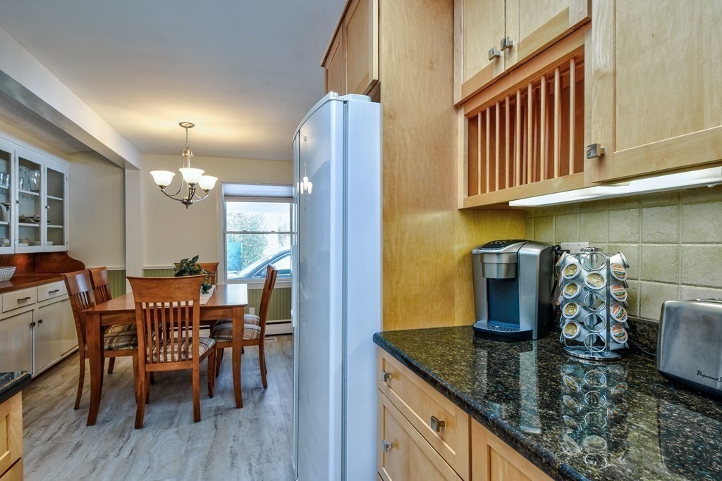 2 Gilmore Road Southborough, MA 01772 - Photo 14 of 33 a kitchen with stainless steel appliances granite countertop a table chairs and a refrigerator