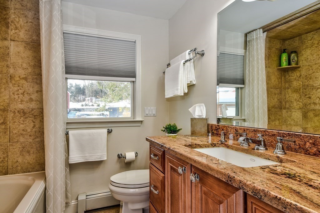 2 Gilmore Road Southborough, MA 01772 - Photo 25 of 33 a bathroom with a granite countertop sink a toilet and a bathtub