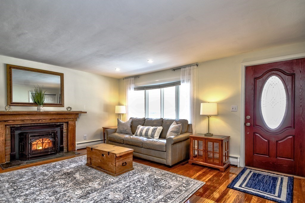 2 Gilmore Road Southborough, MA 01772 - Photo 8 of 33 a living room with furniture a window and a fireplace