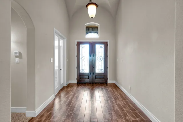 a view of an empty room with a fireplace and a window