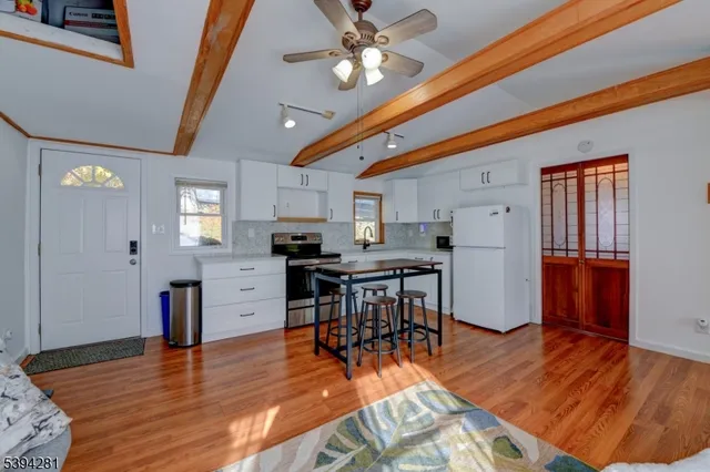 a view of kitchen with cabinets and wooden floor