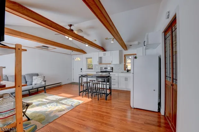 a kitchen with stainless steel appliances granite countertop a refrigerator and a stove top oven