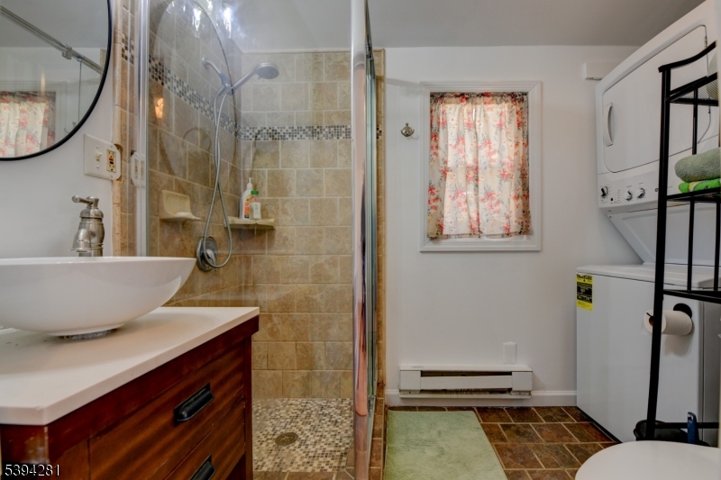 9 Woods Road Branchville, NJ 07826 - Photo 9 of 21 a bathroom with a granite countertop sink a toilet and a mirror