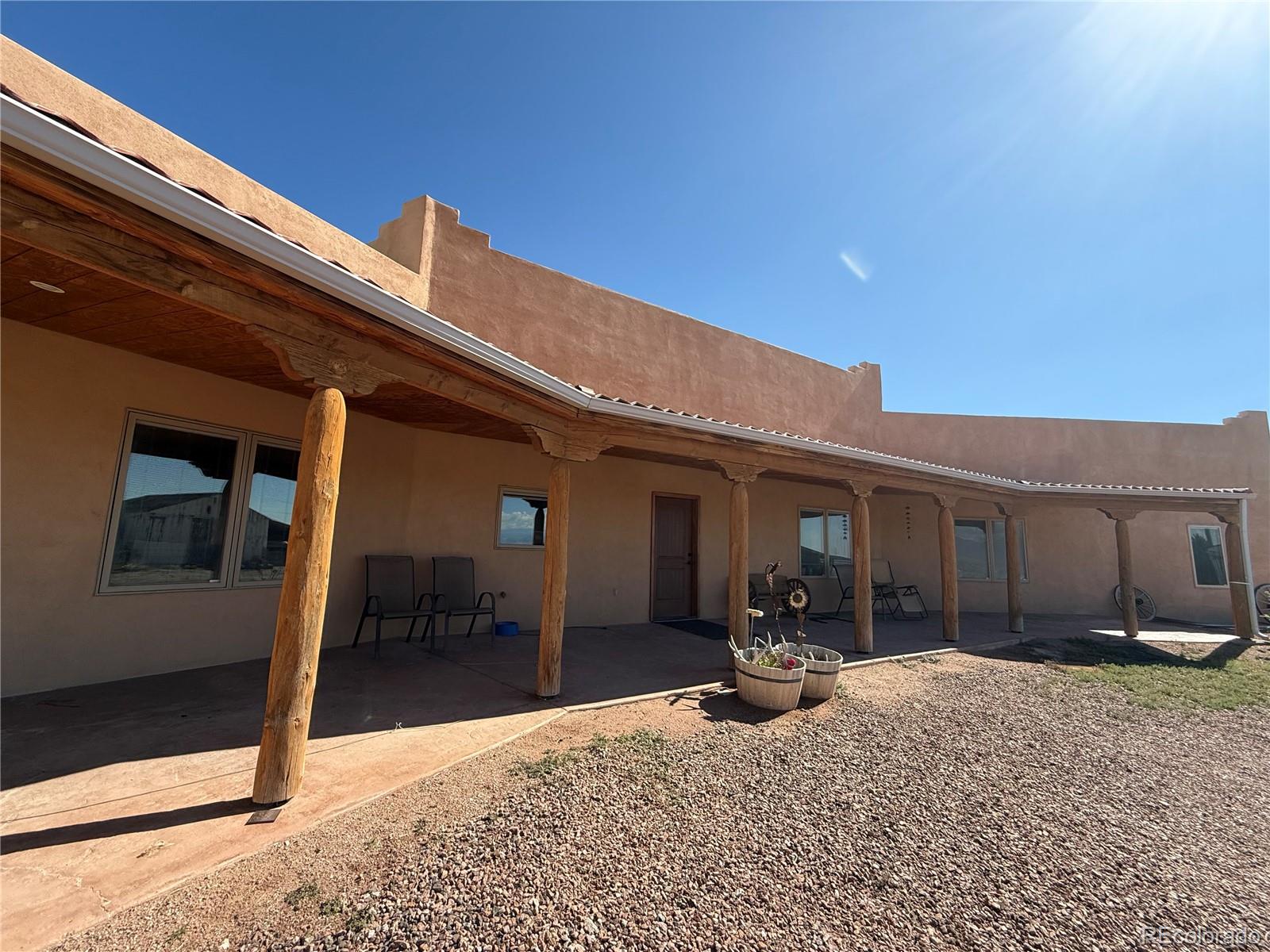 a view of a porch with furniture and a yard