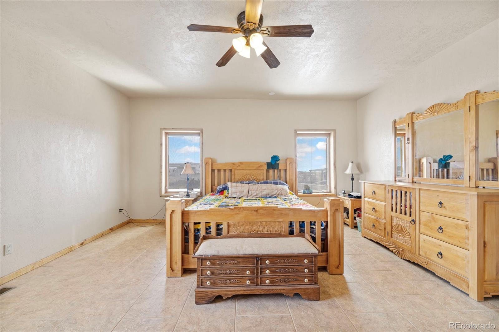 988 P Street Penrose, CO 81240 - Photo 12 of 48 a view of a bedroom with furniture window and a ceiling fan