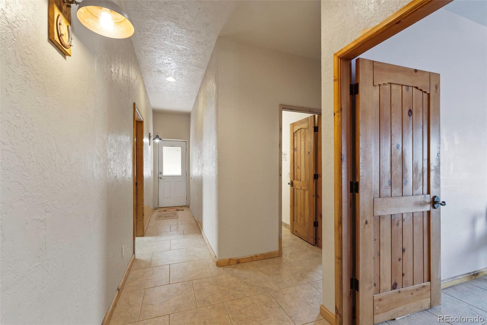 988 P Street Penrose, CO 81240 - Photo 17 of 48 a view of a hallway with wooden floor