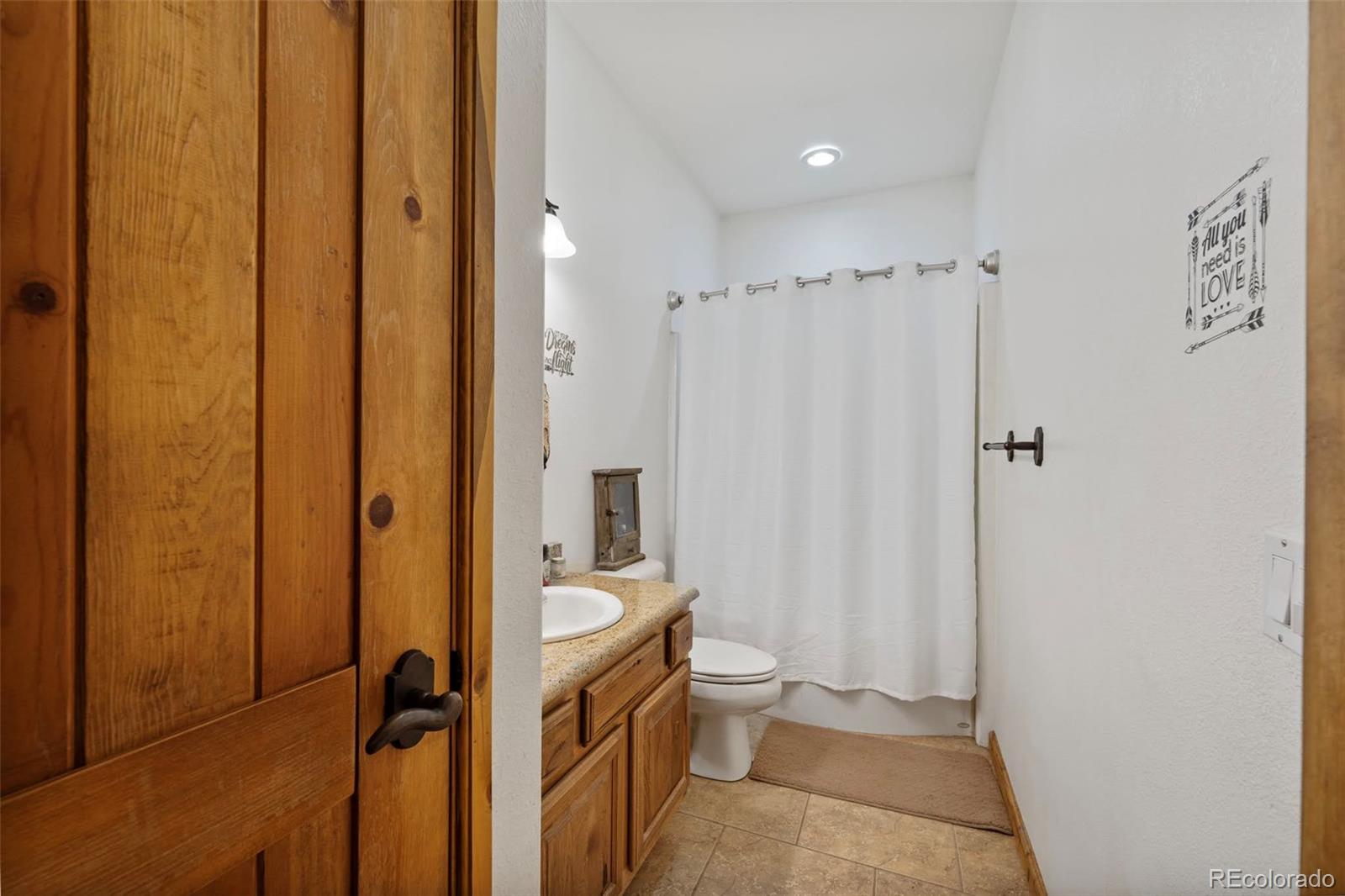 988 P Street Penrose, CO 81240 - Photo 18 of 48 a bathroom with a shower and a toilet