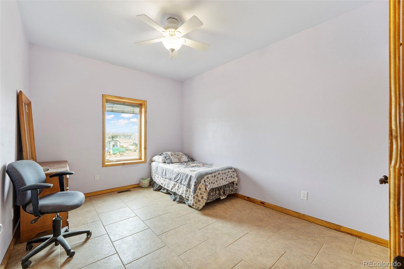 988 P Street Penrose, CO 81240 - Photo 20 of 48 a living room with furniture and a window