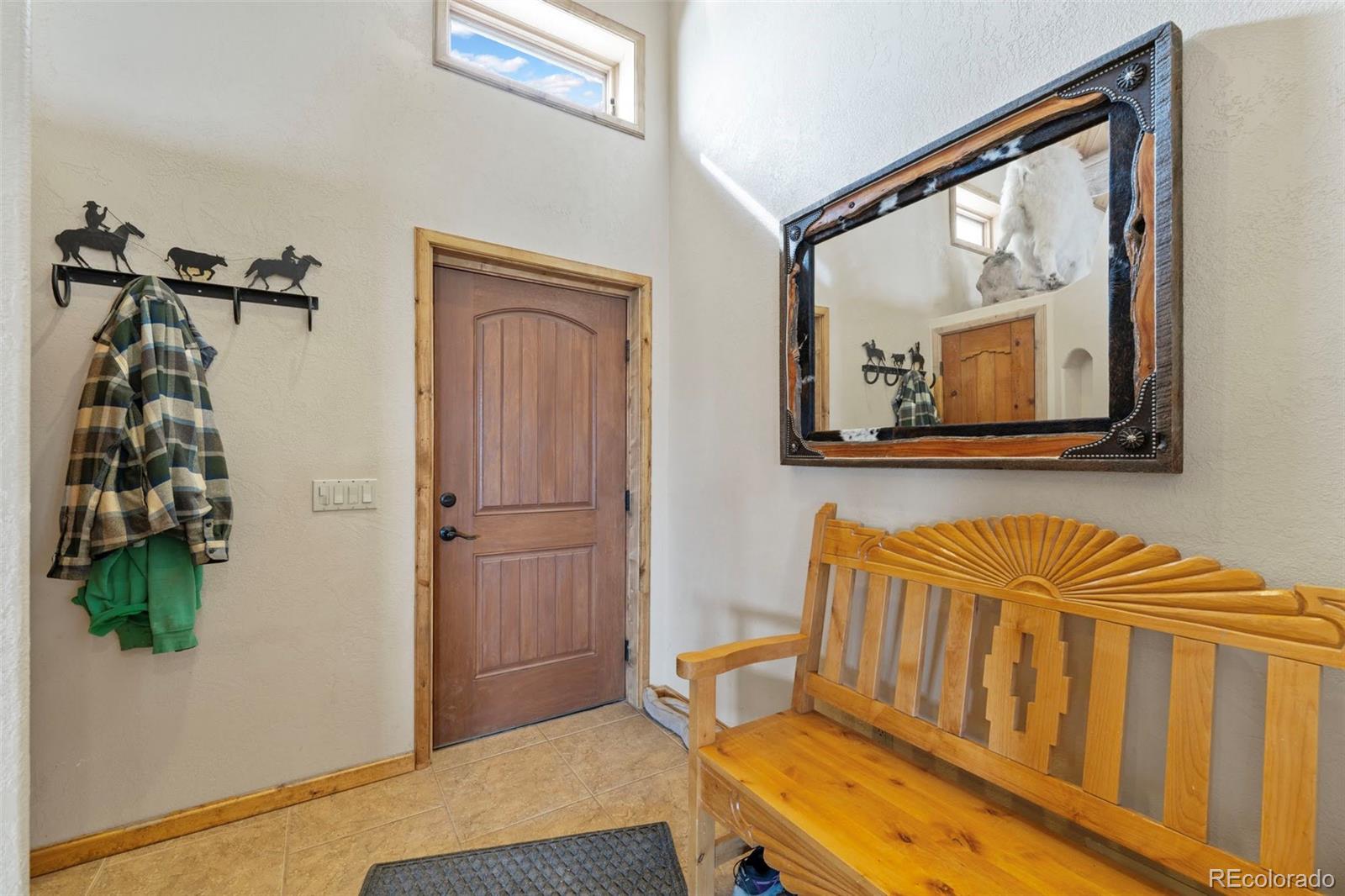 988 P Street Penrose, CO 81240 - Photo 3 of 48 a hallway with a table and a mirror