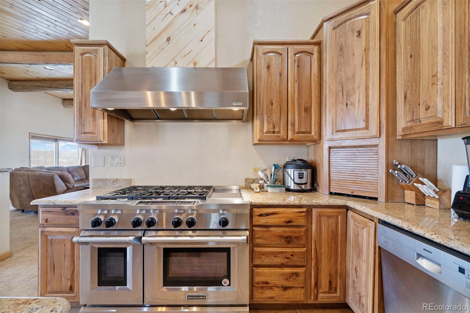 988 P Street Penrose, CO 81240 - Photo 4 of 48 a kitchen with stainless steel appliances granite countertop a stove and a sink